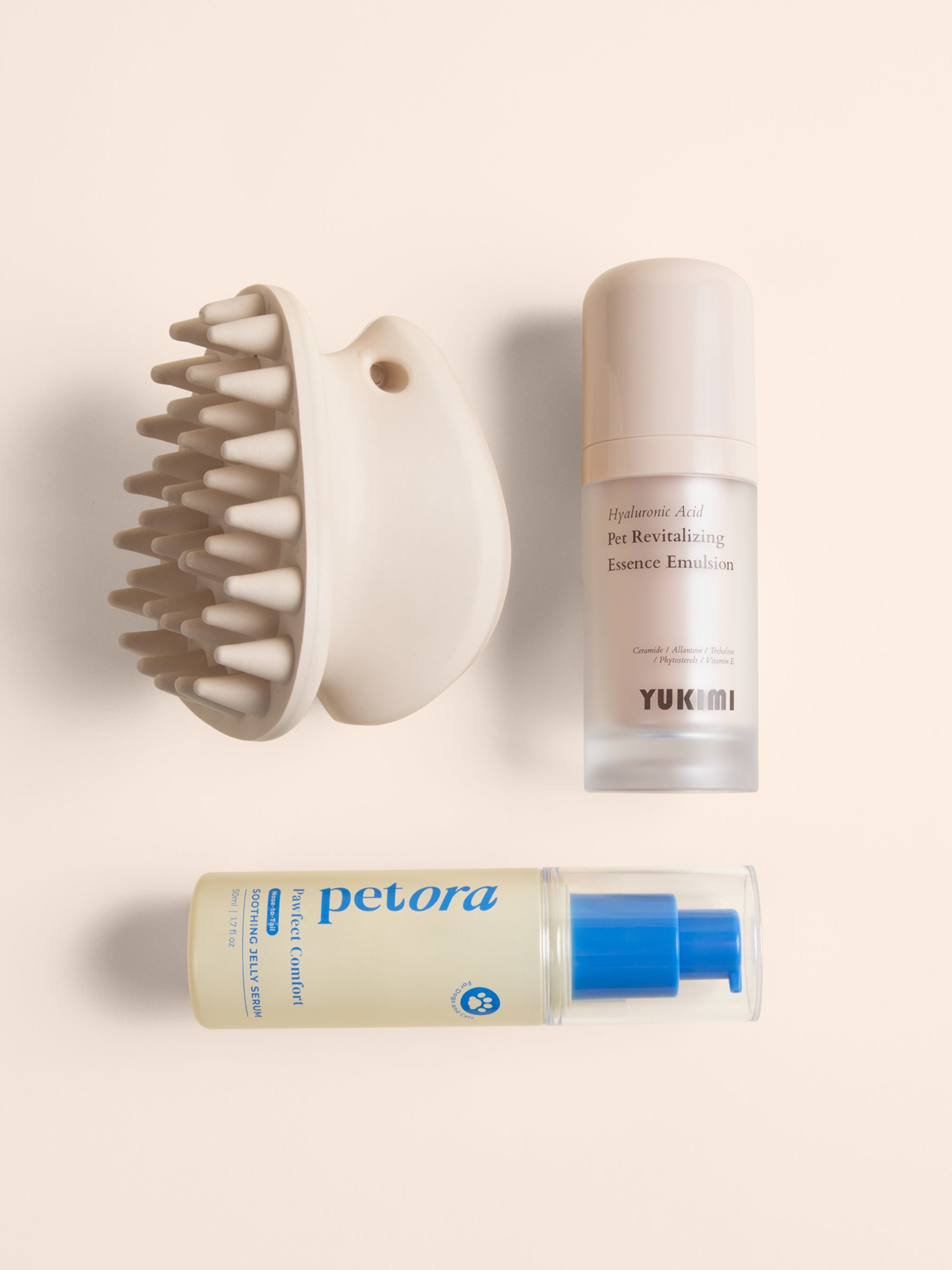 maxbone coat therapy brush, YUKIMI hyaluronic acid pet revitalizing essence emulsion, petora pawfect comfort soothing jelly serum, a flat lay picture of all the products in the Cleo Society Glow Edit.