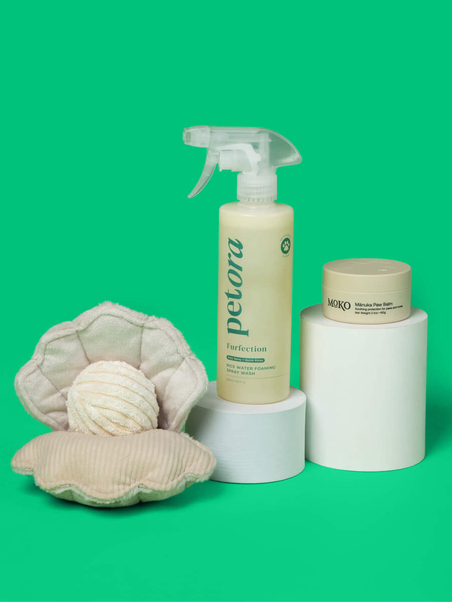 Petora Rice Water Shampo, Moko Manuka pet paw balm, and Lambwolf Oyster POP toy on a fresh green background