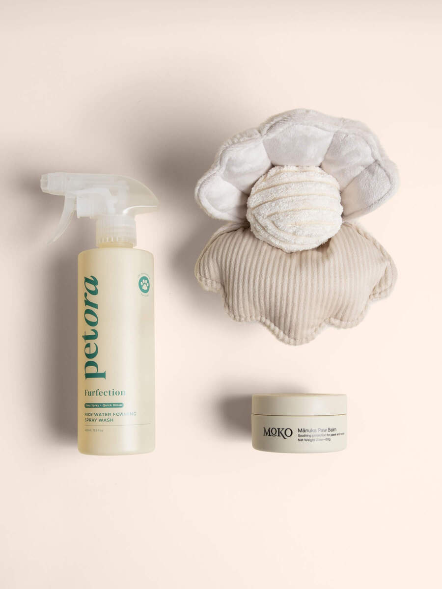 Petora Rice Water Shampo, Moko Manuka pet paw balm, and Lambwolf Oyster POP toy on a beige background